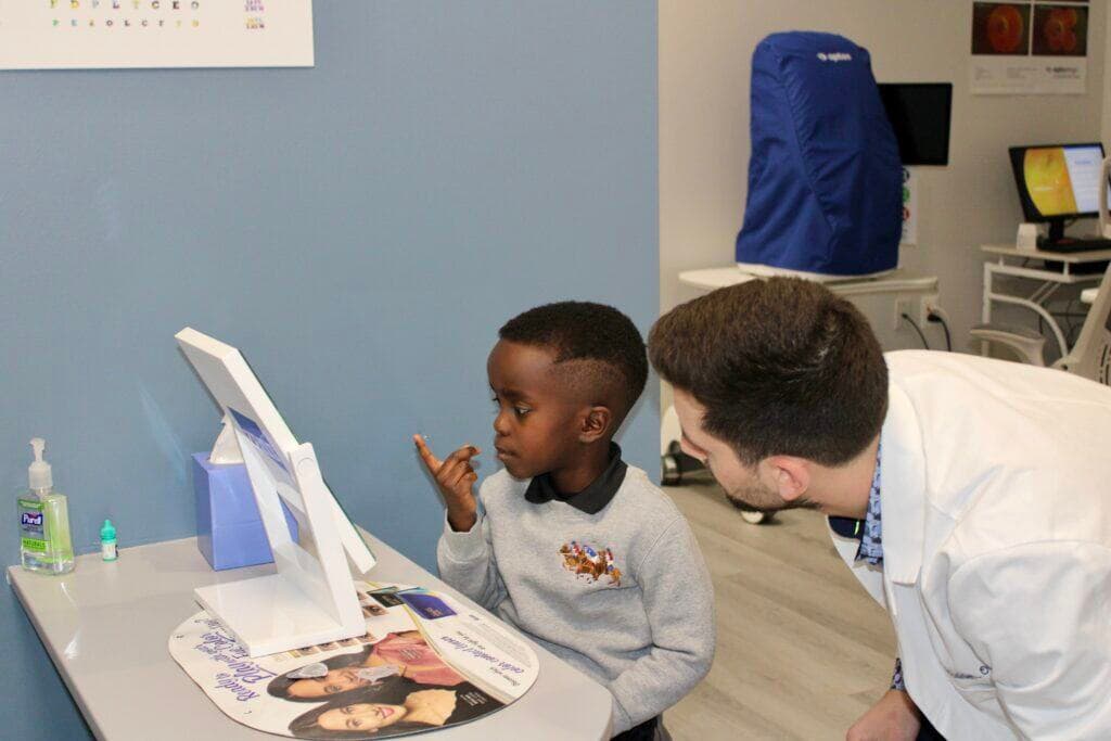 Doctor teaching a child how to insert Ortho-K lenses