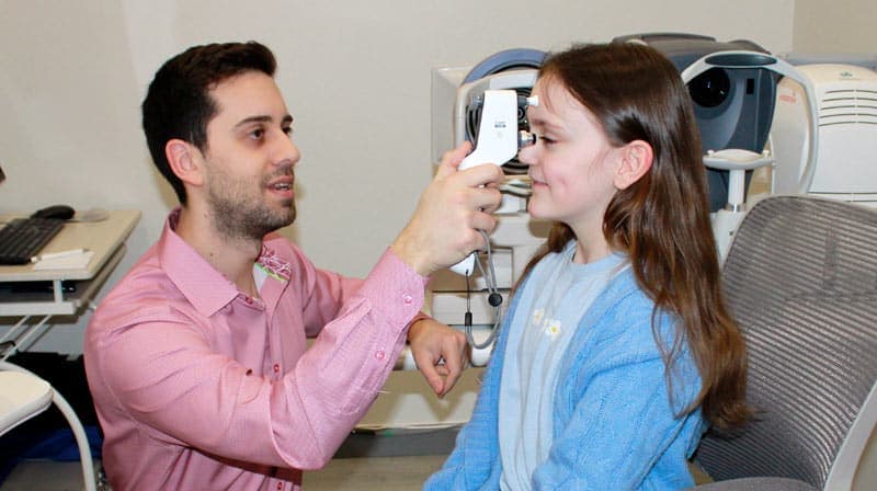 Child having an eye exam at Beyond Eyecare