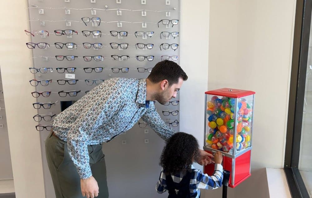 Optician adjusting glasses display at Beyond Eyecare