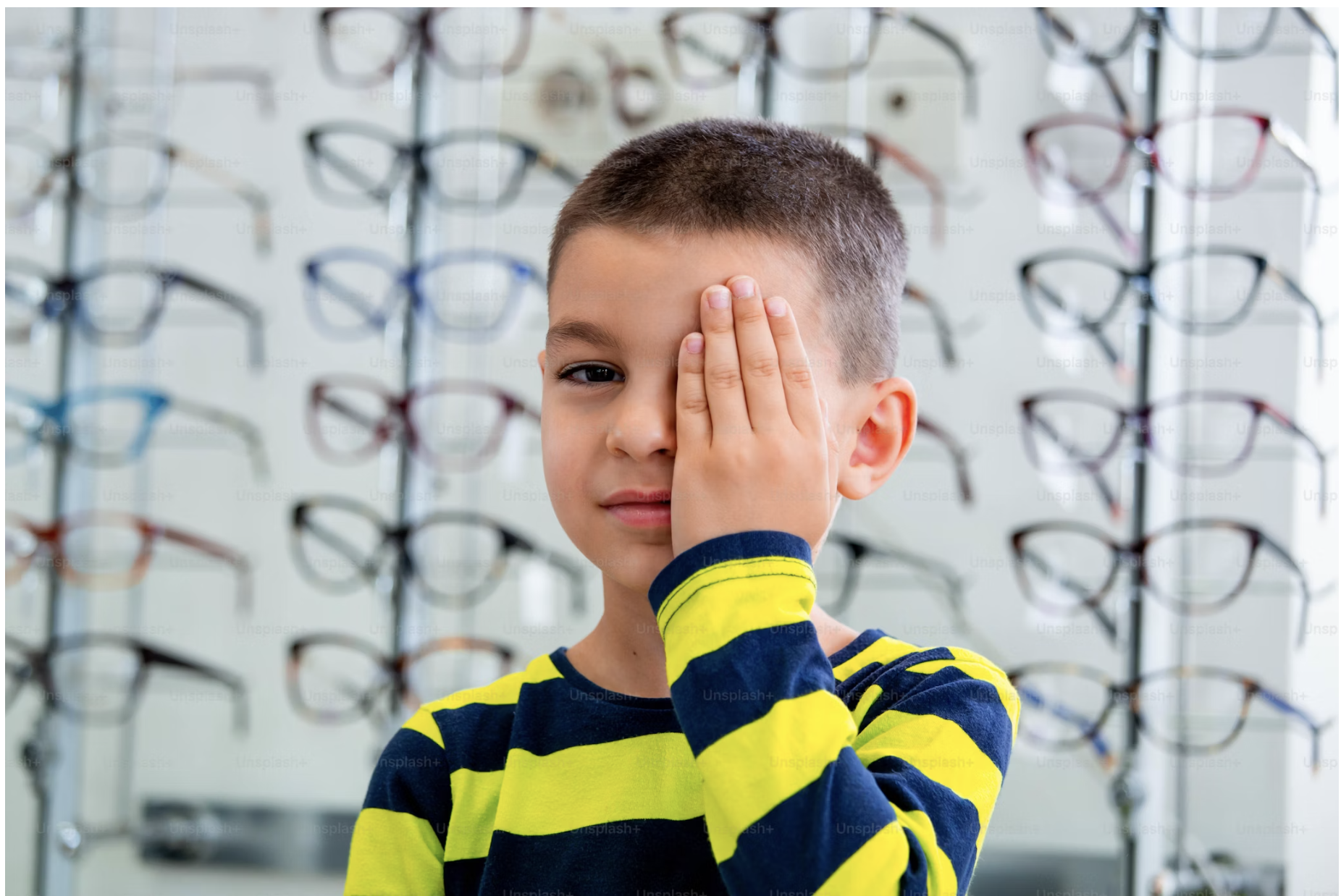 Child with glasses receiving pediatric eye exam at Beyond Eyecare